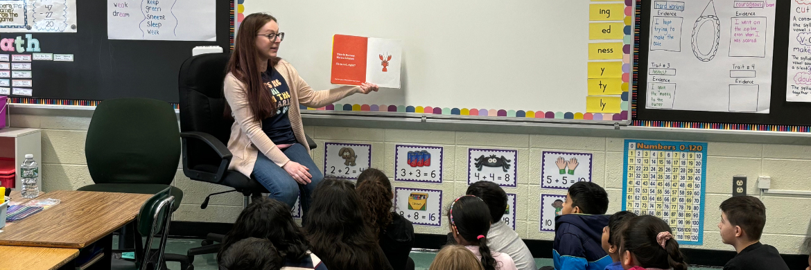 Ms Erica reading to a class 