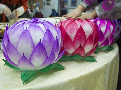 red, purple, and green lotus shaped paper lanterns