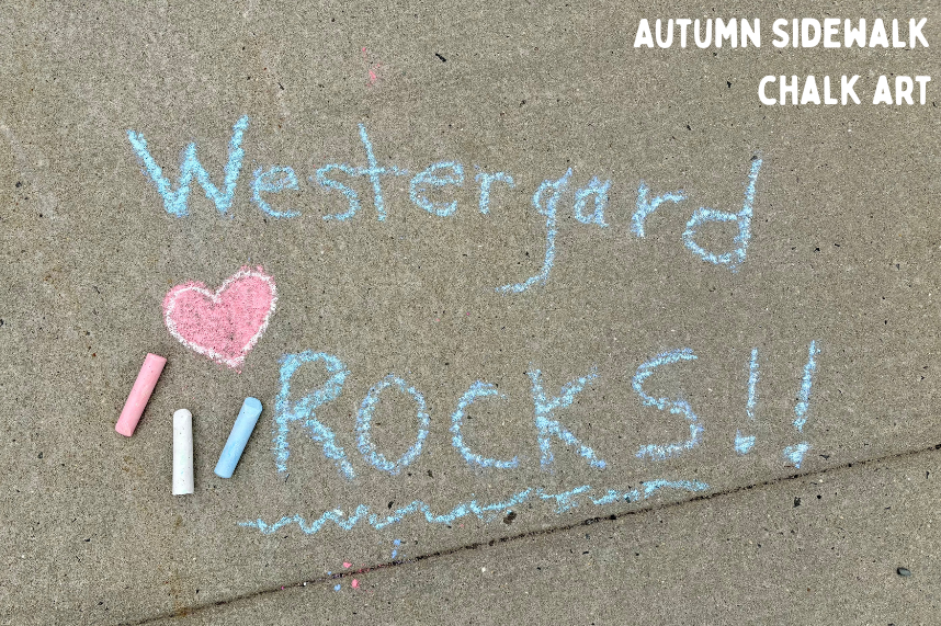"Westergard Rocks" with a pink heart written in blue chalk on sidewalk