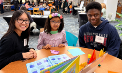 Volunteers helping with origami