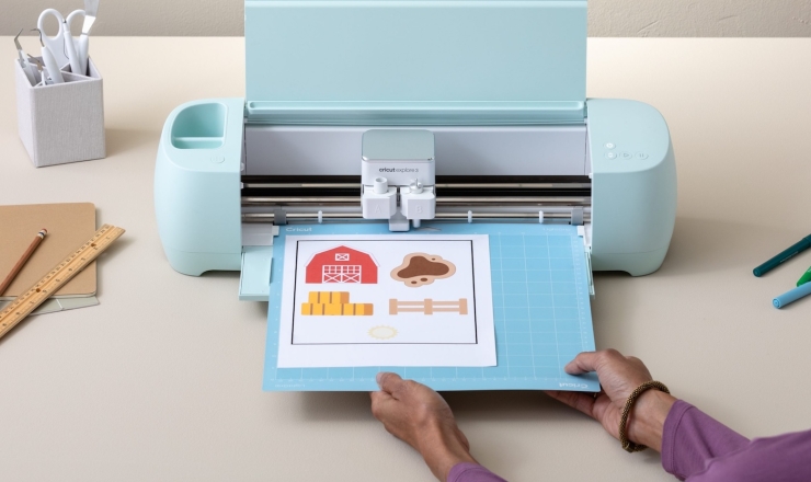 Person using Cricut maker machine