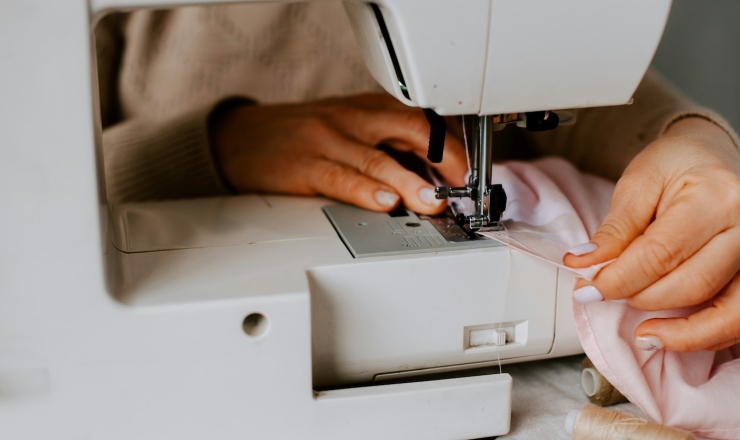 Person using sewing machine