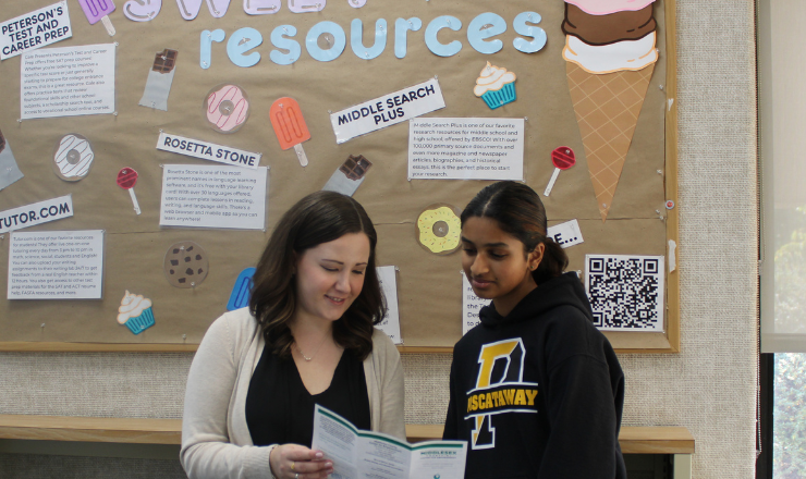 Ms Kate-Lynn helping a teen with resources
